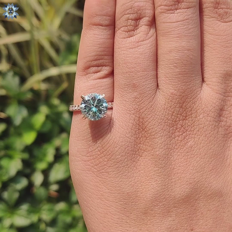 Moissanite pave ring with hidden halo in rose gold setting.
