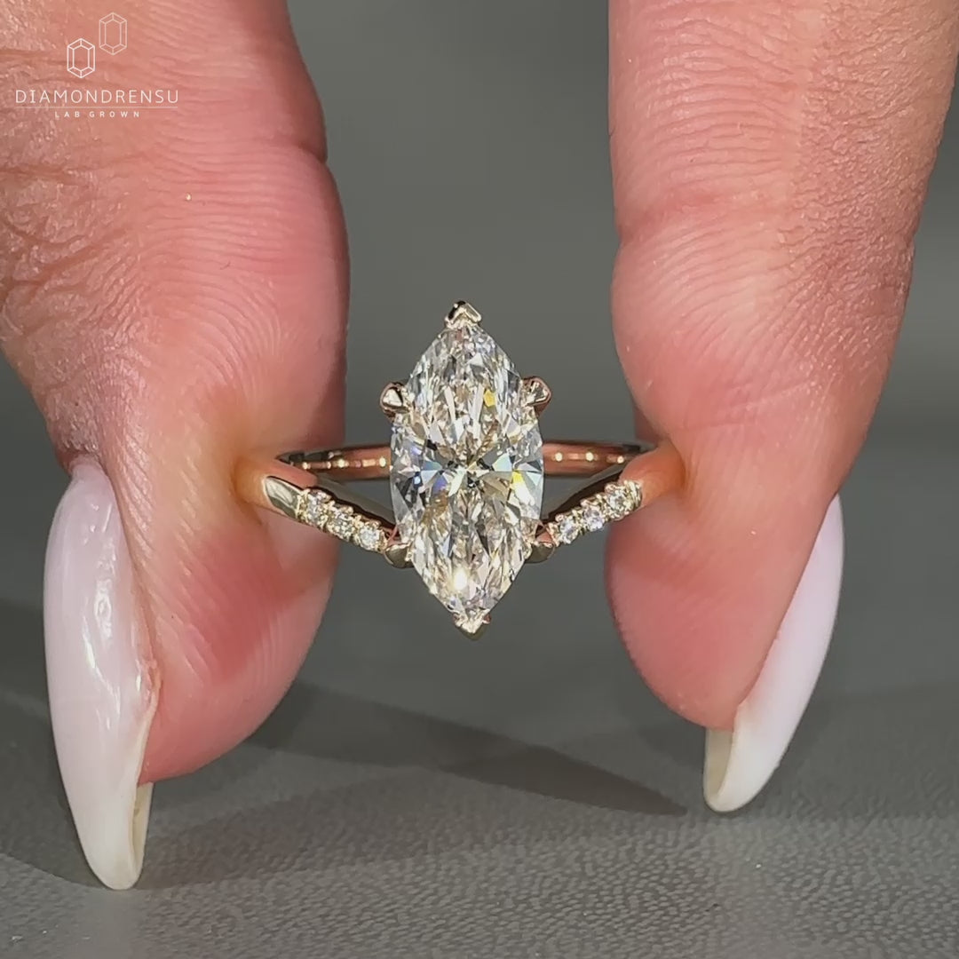 Marquise Diamond Center Stone placed in yellow gold ring style.
