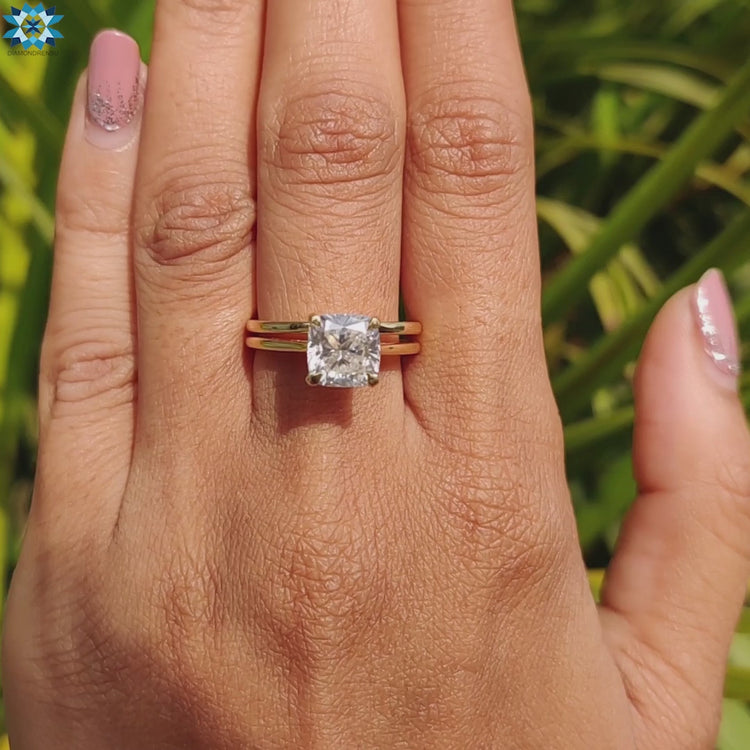 Yellow gold ring featuring solitaire moissanite stone.
