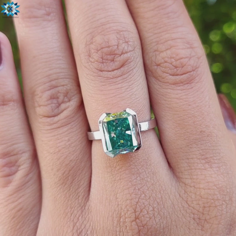 Radiant cut solitaire moissanite ring in white gold band.
