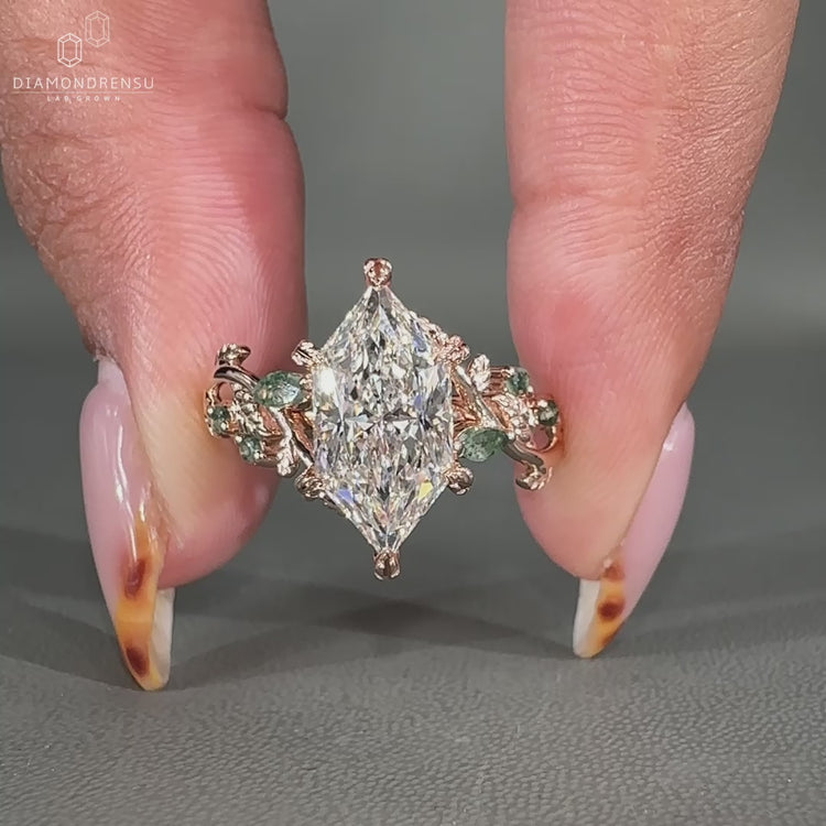 Rose gold ring with marquise and round side stones