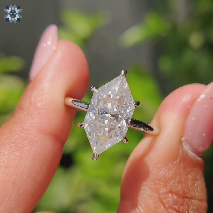 Hidden halo engagement ring featuring Dutch marquise cut Moissanite and round cut accents.
