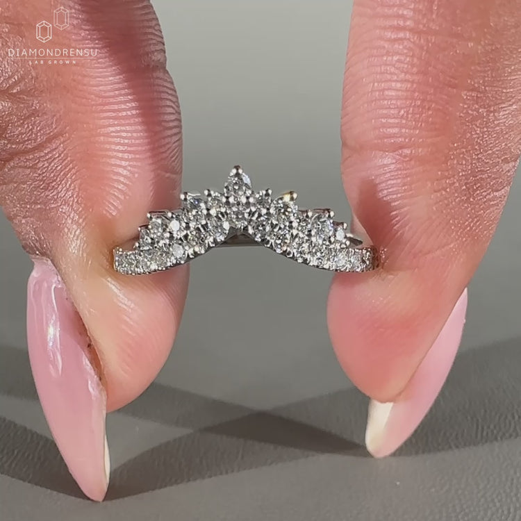 Curved wedding band with round diamonds.
