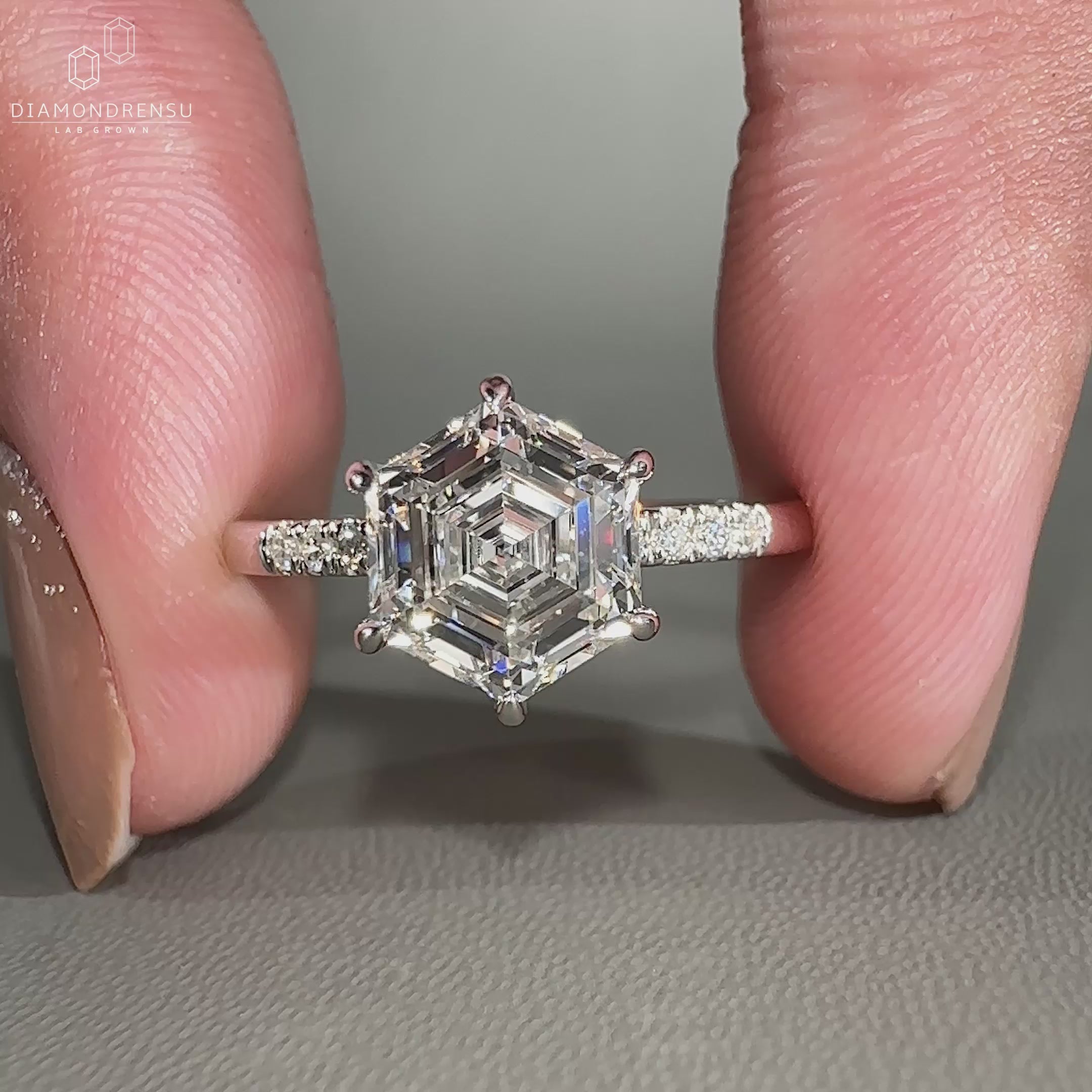 Round cut side stones enhance pave setting ring.
