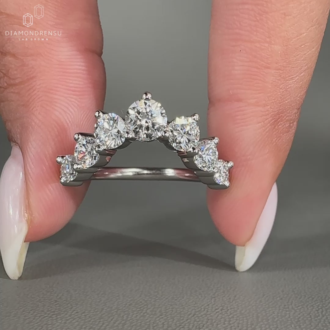Round diamond band in a half eternity style with prong setting.