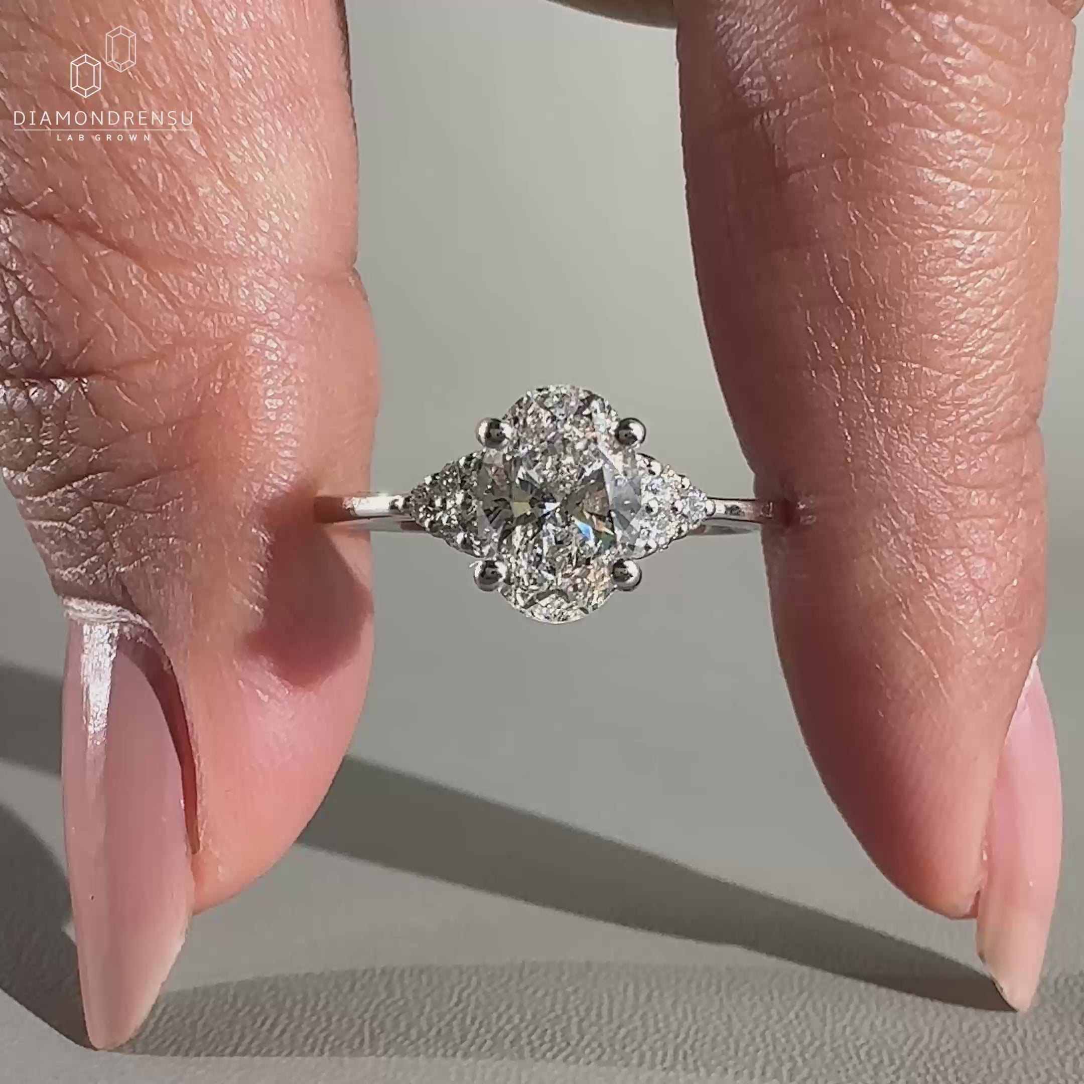 Muse setting ring featuring prong setting and round side stones.
