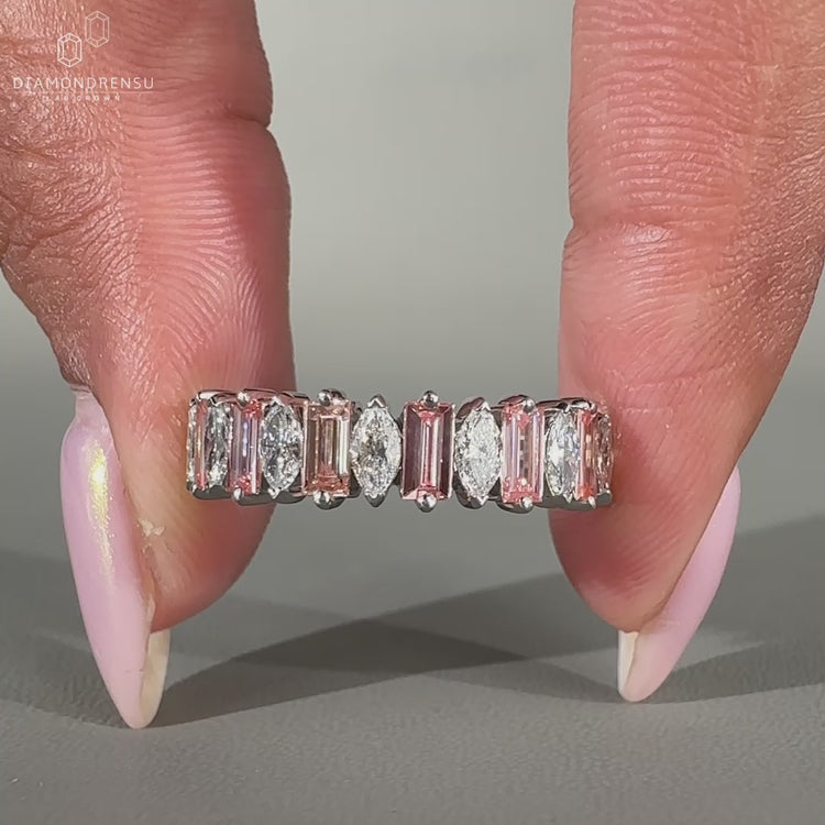 Half eternity band featuring marquise and baguette cut diamonds in white gold.
