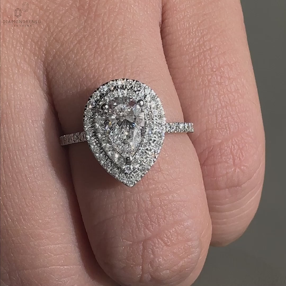 Halo ring crafted with a pear shaped diamond and set as a uk engagement ring.
