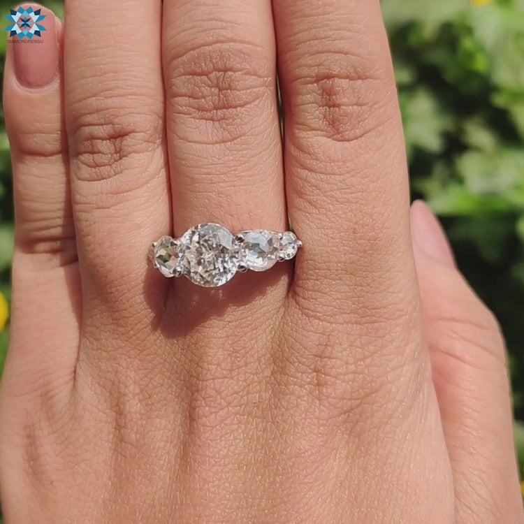 White gold ring with prong setting and moissanite stones.
