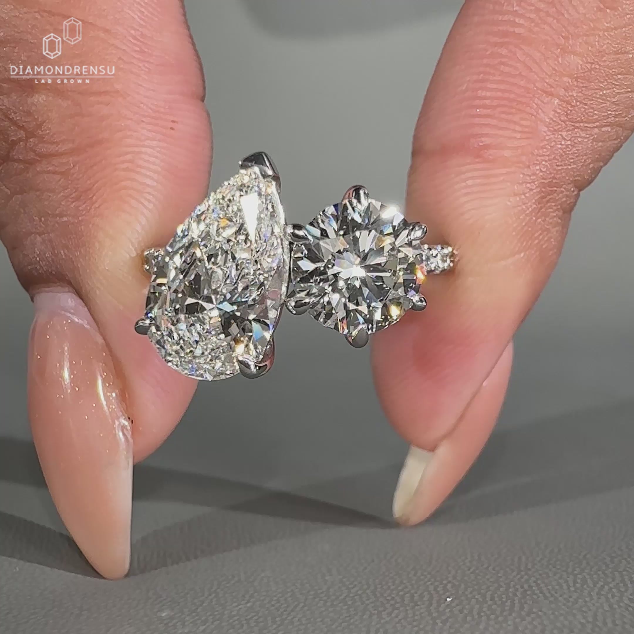 Elegant pave setting ring with two stones in claw prong design.
