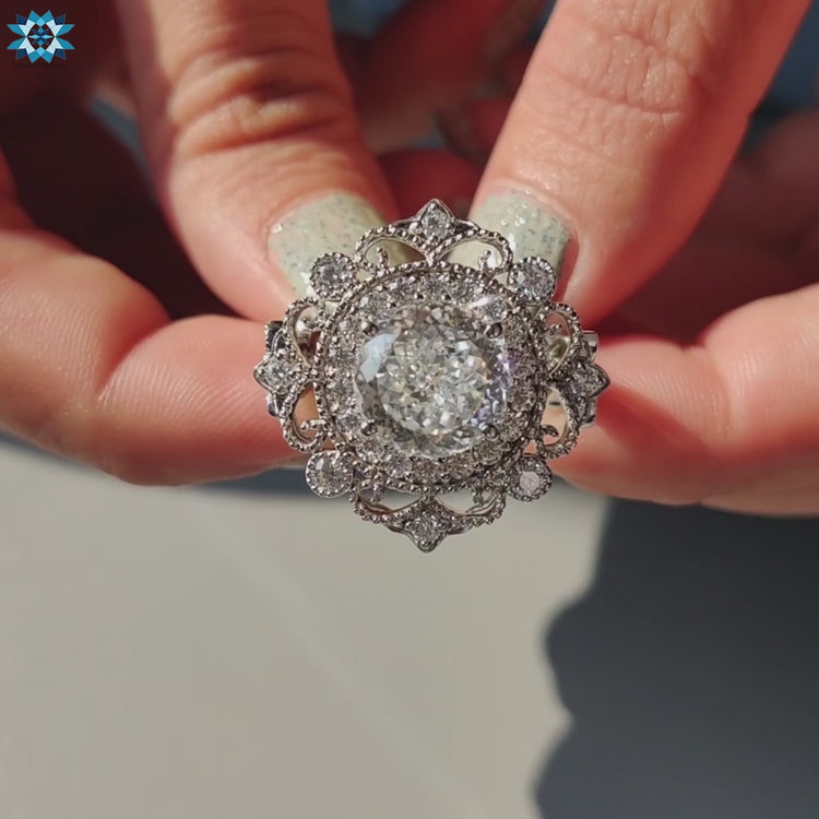 Elegant moissanite halo ring with detailed milgrain border.

