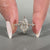 Shared prong pave band ring featuring seven diamonds.
