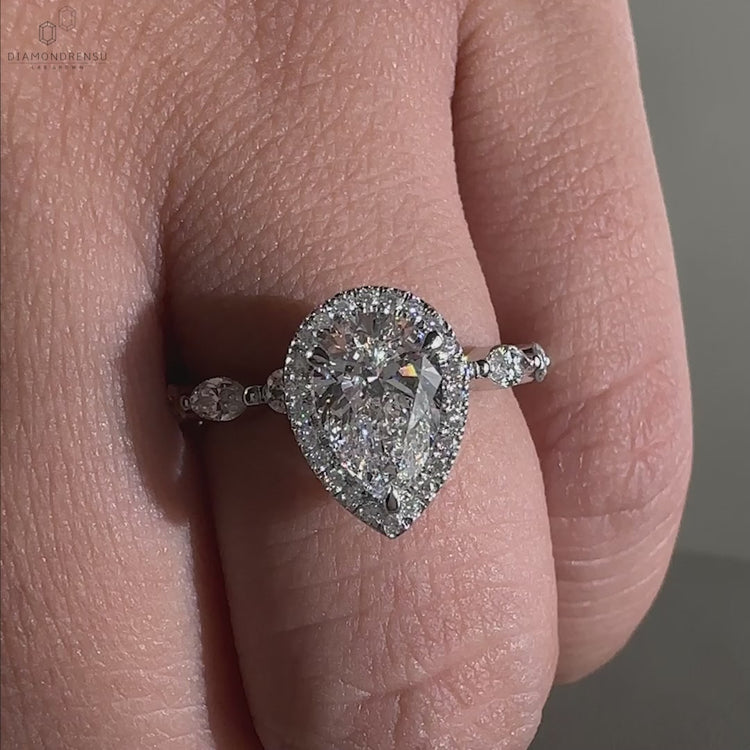 Marquise and Round Side Stones paired with a pear shaped engagement ring for a timeless and elegant style.