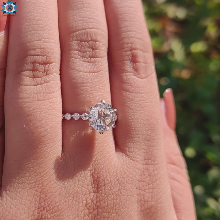 Handmade ring with round cut moissanite in a claw and pave setting.
