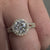 Round diamond center stone with pave band.
