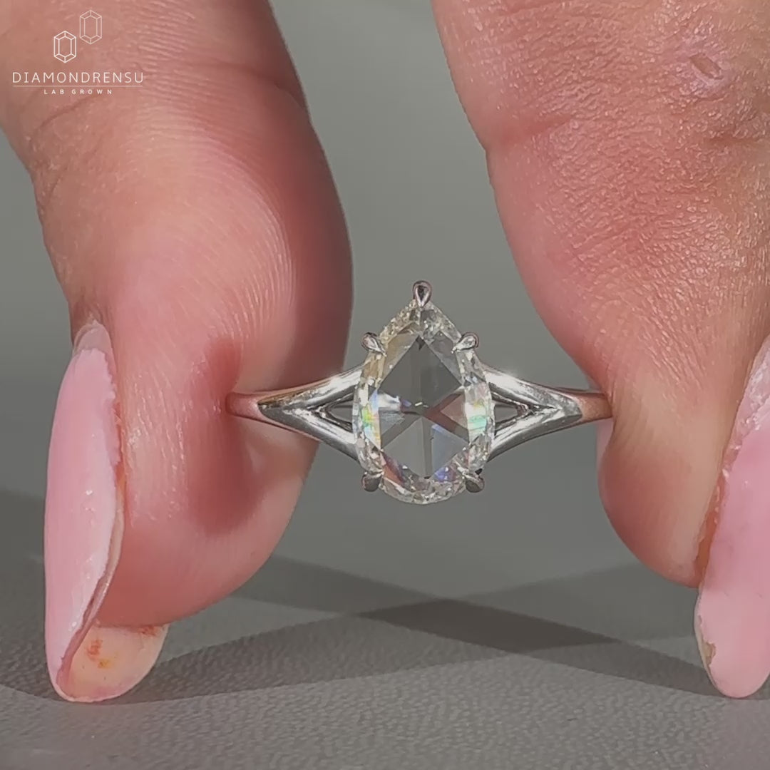 Pear rose cut ring adds shape to the solitaire engagement ring.
