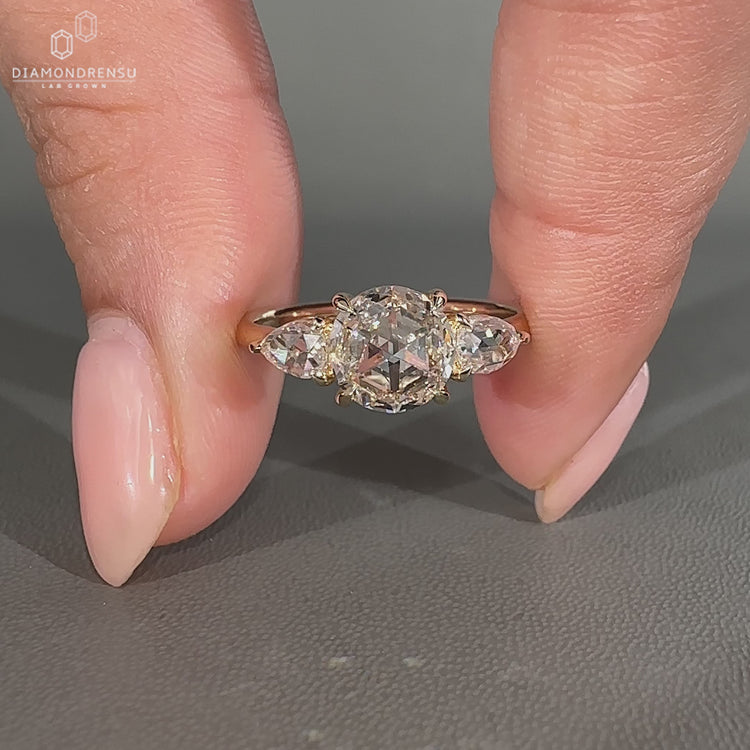 Three stone ring with round and pear rose diamonds.
