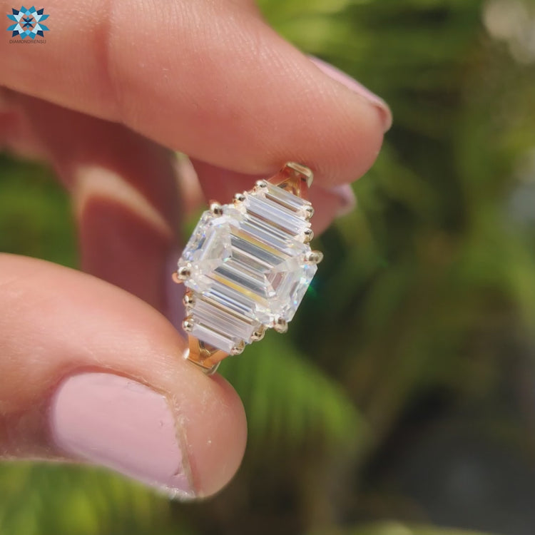 Yellow gold ring with emerald cut moissanite center stone.
