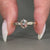 Three stone engagement ring with oval and round diamonds