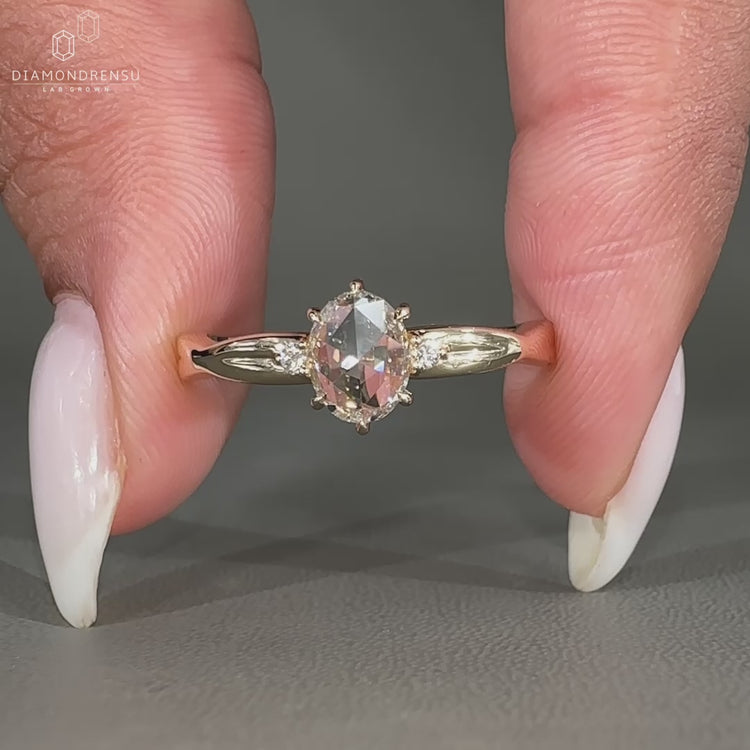 Three stone engagement ring with oval and round diamonds