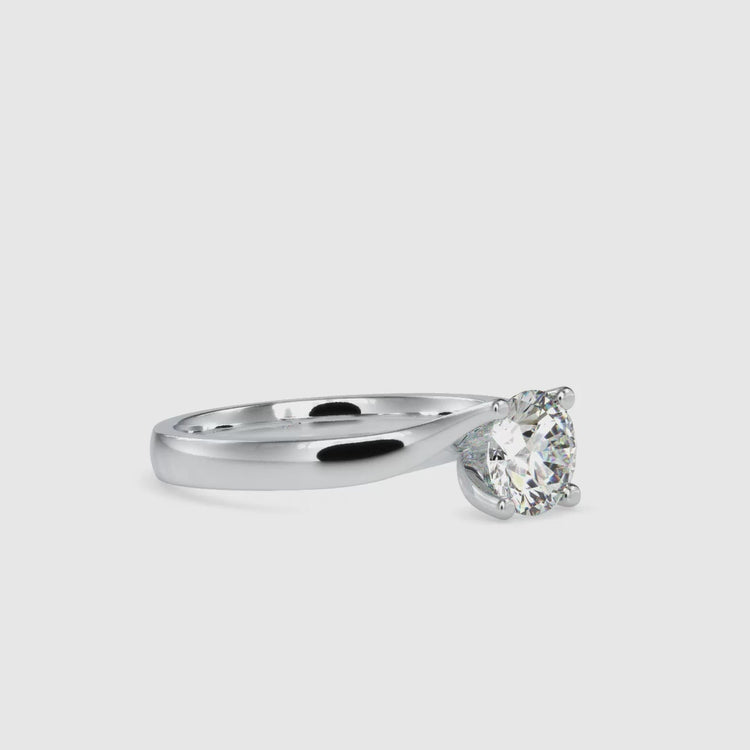 Rose gold ring with bypass band and solitaire diamond.