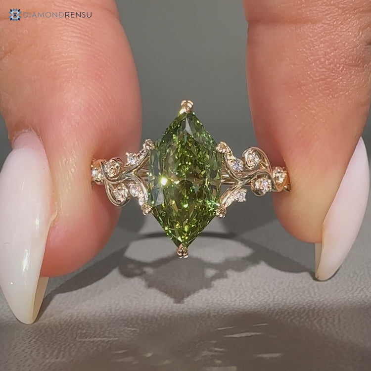 Green centre diamond ring with round side stones.