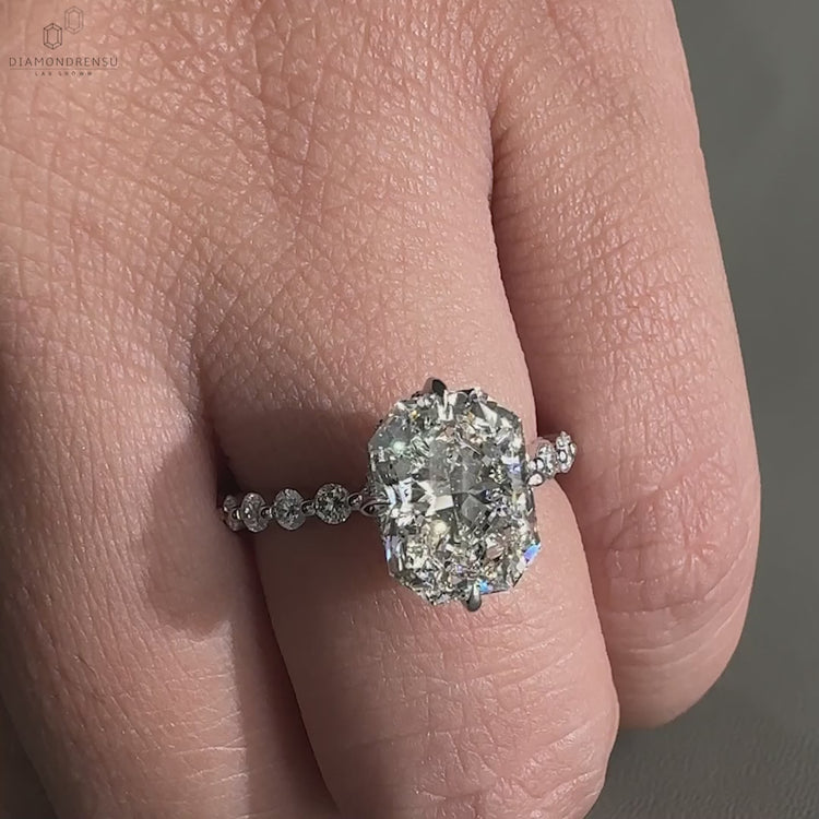 Engagement ring hidden halo crafted with a radiant engagement ring centre stone and claw prongs.