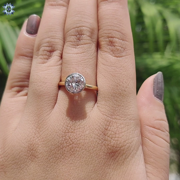 Elegant bezel set engagement ring with round moissanite.
