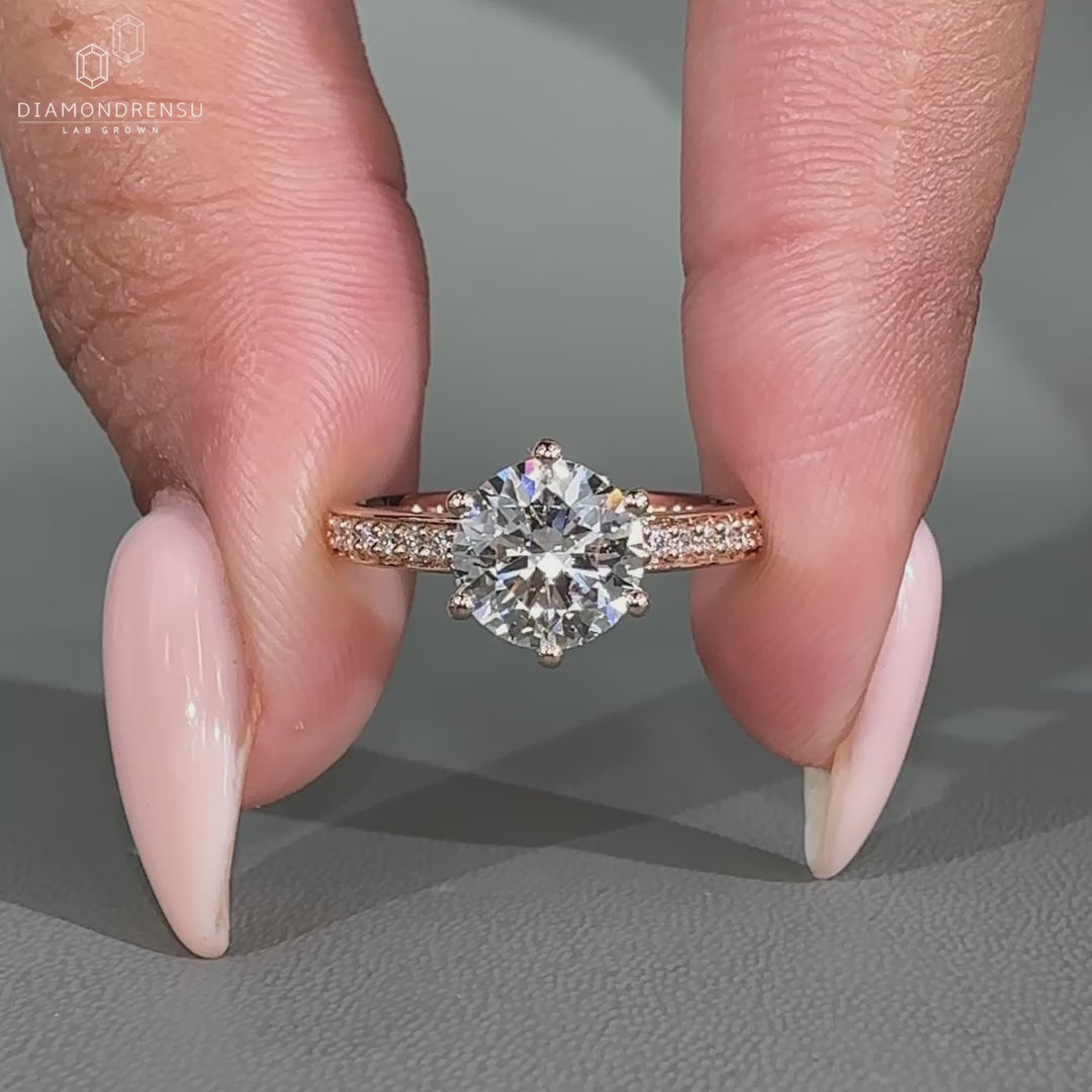 Hidden halo engagement ring featuring a round lab grown diamond.
