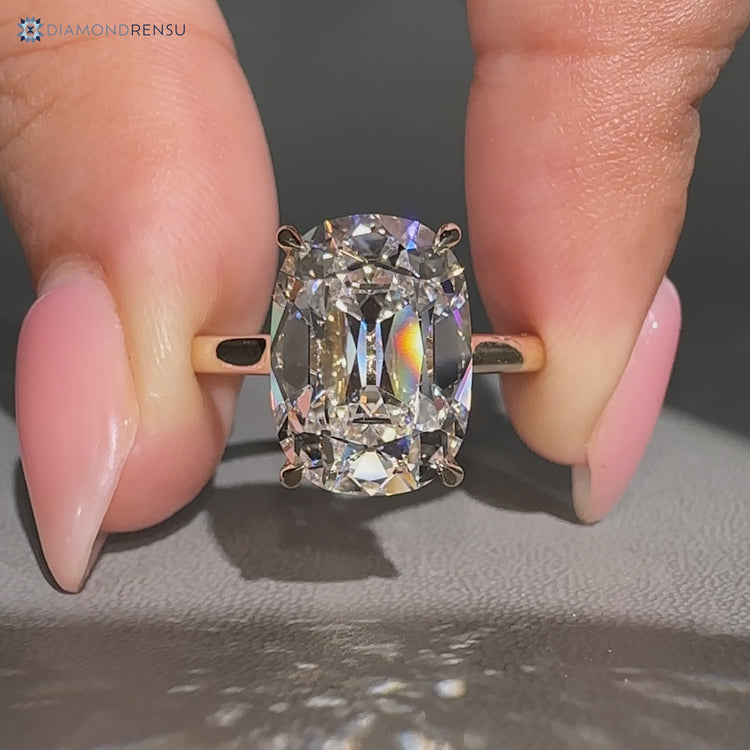 Cushion OMC diamond ring with cathedral setting.
