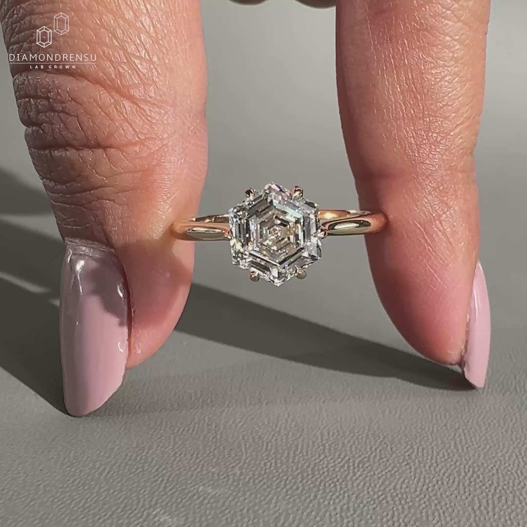 Hexagon diamond ring featuring a 6 claw prong setting.
