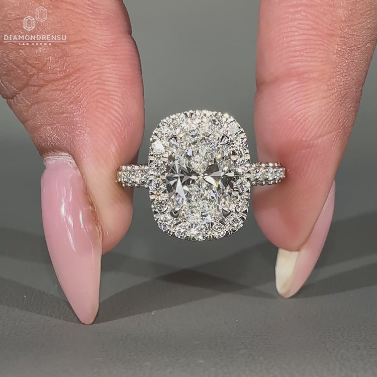 Halo diamond ring featuring three side pave engagement band design.
