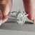 Round cut diamond halo ring featuring a handmade design.
