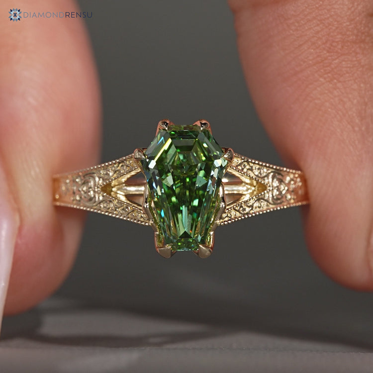 Green centre diamond ring with split shank design.