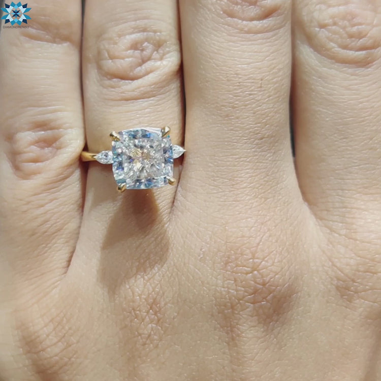 Diamondrensu UK ring with three moissanite stones in yellow gold.
