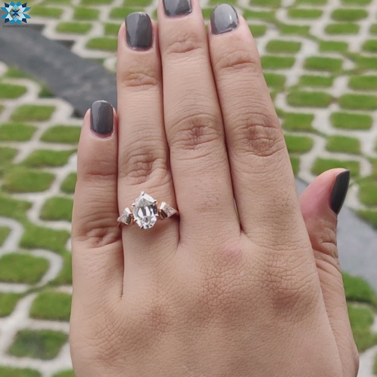 Rose gold three stone ring with vintage-inspired cuts.
