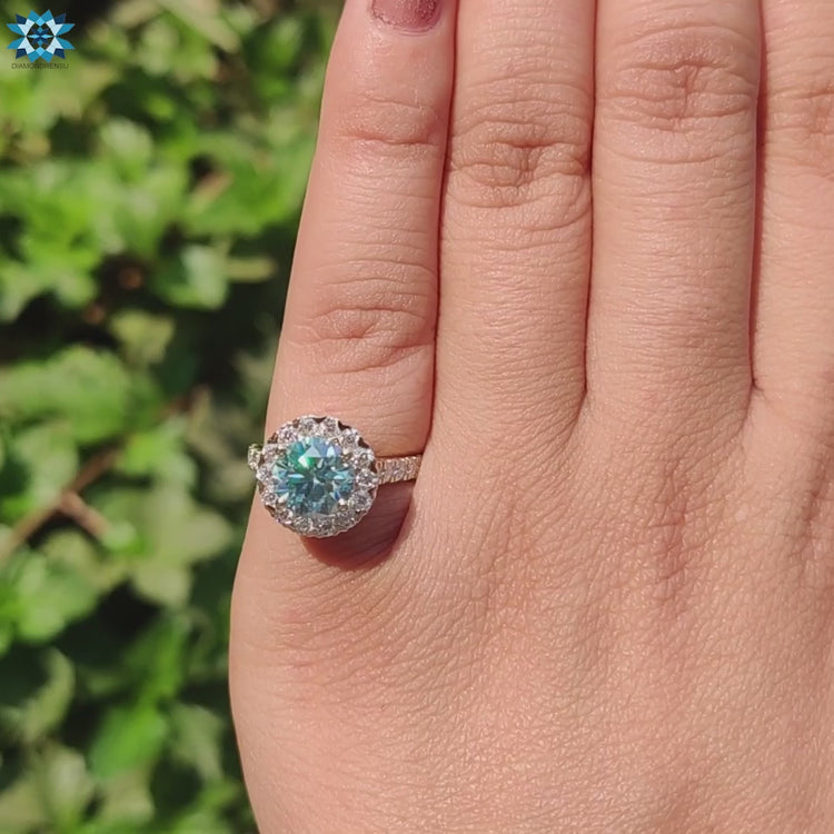 Halo ring with round moissanite and yellow gold band.
