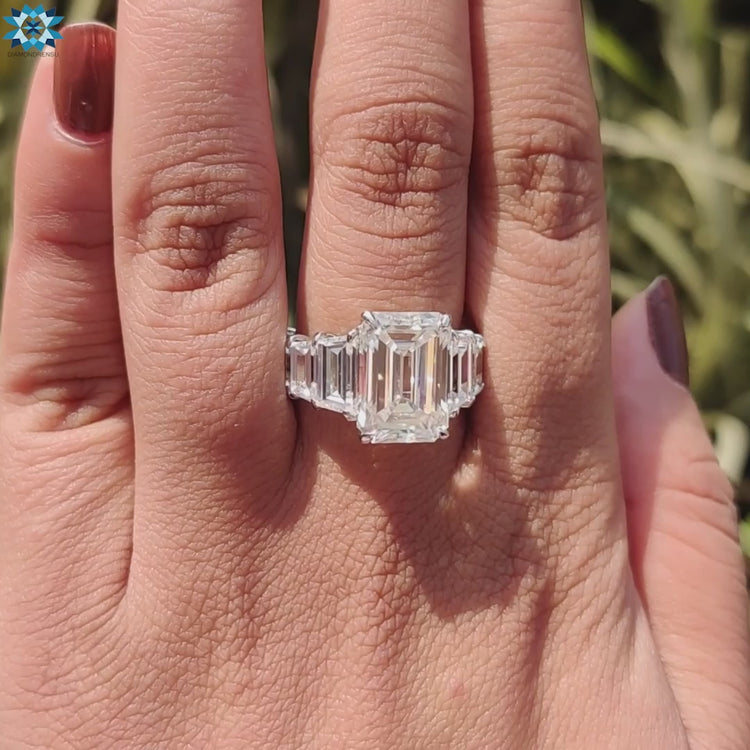 Moissanite engagement ring with emerald center and delicate pave setting.
