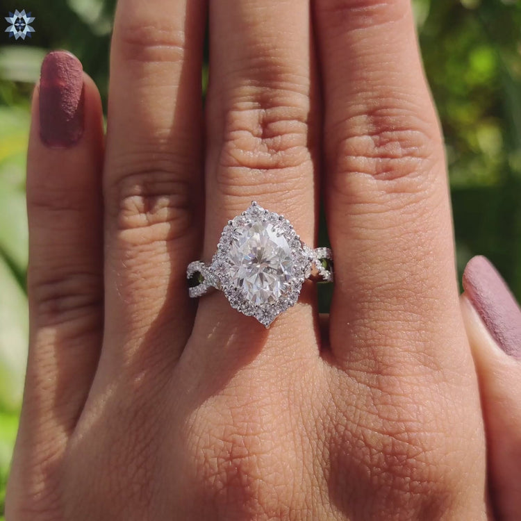 Double claw prong ring with oval cut moissanite center.
