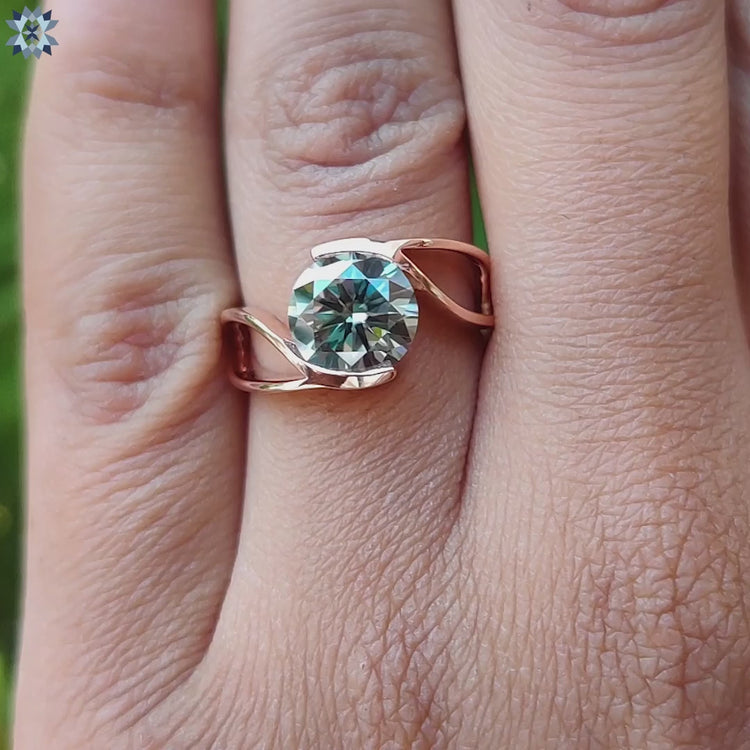 Rose gold solitaire ring with tension set moissanite.

