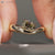 Yellow cushion OMC diamond ring with east to west setting.
