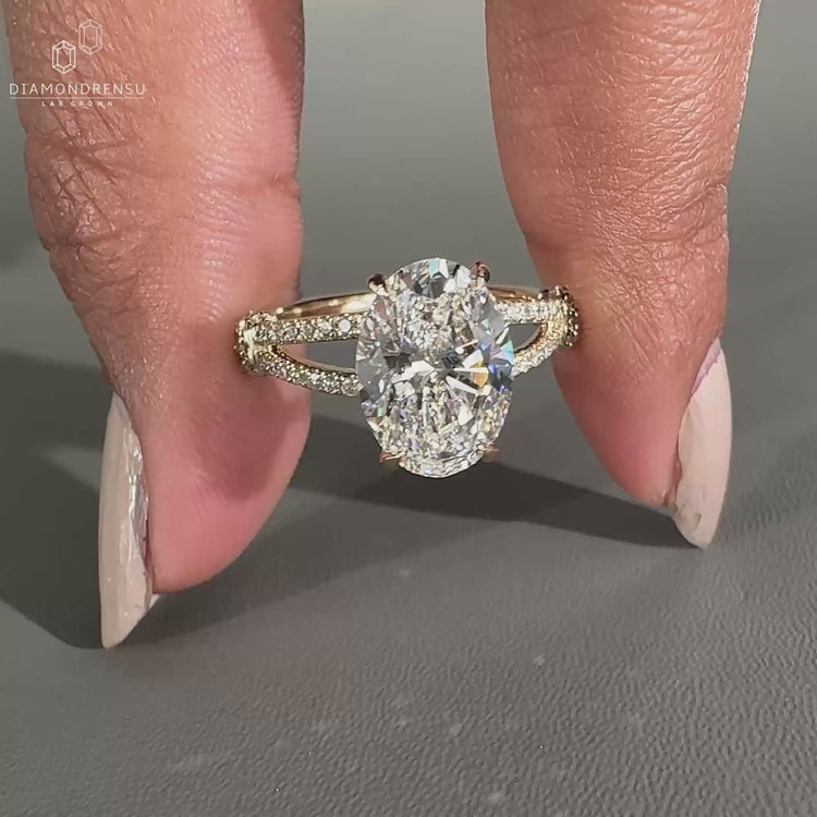 Round cut diamond halo ring featuring a split shank pave engagement ring style.
