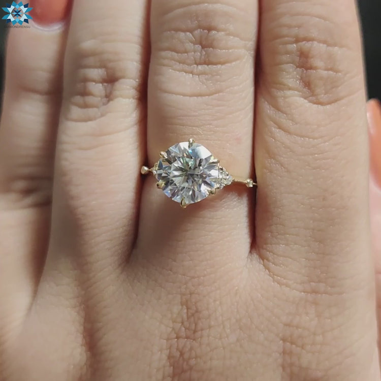 Prong set round moissanite engagement ring in muse style.
