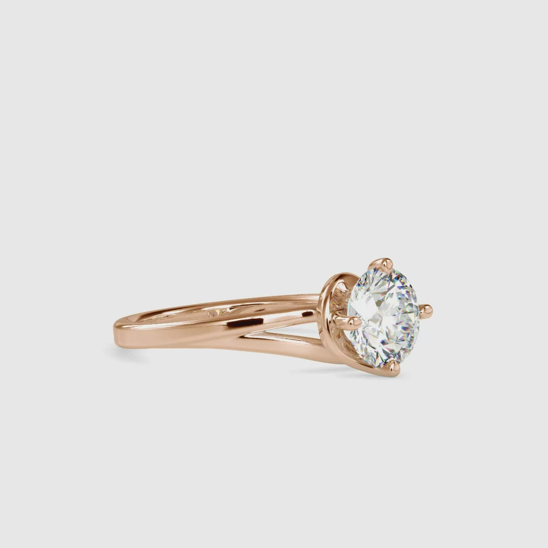 Stunning gold bypass ring featuring a round solitaire diamond.