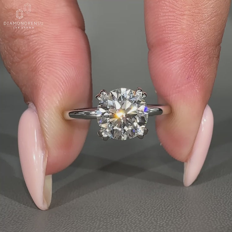 Round diamond engagement ring crafted in tulip ring setting.

