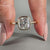 This bezel set engagement ring includes one cushion cut diamond in a secure setting.
