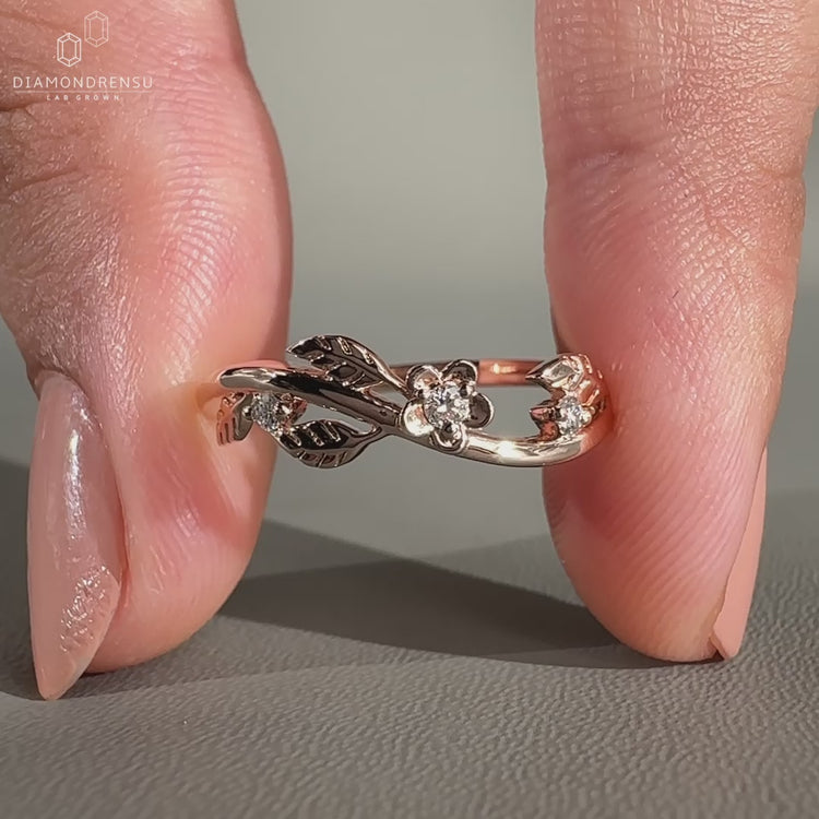 Round cut diamond band crafted in rose gold with a handmade finish.