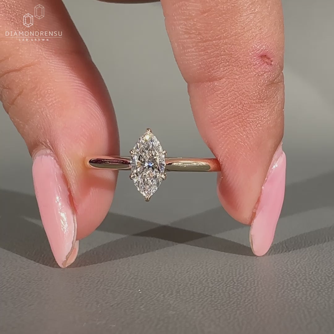 Solitaire setting ring featuring a marquise diamond.
