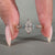 It also has round cut side stones with a v prong setting.
