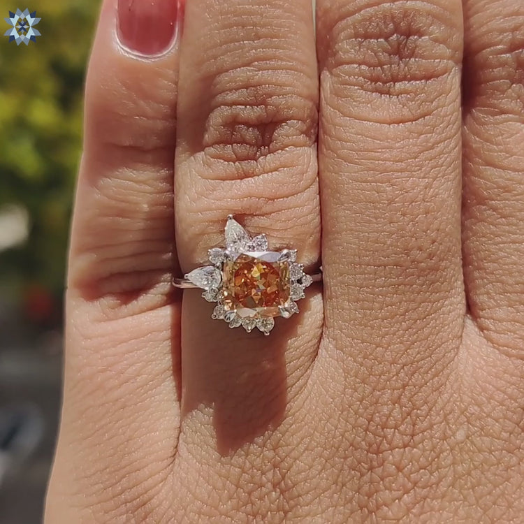 Champagne moissanite cushion cut ring with pear and round side stones.
